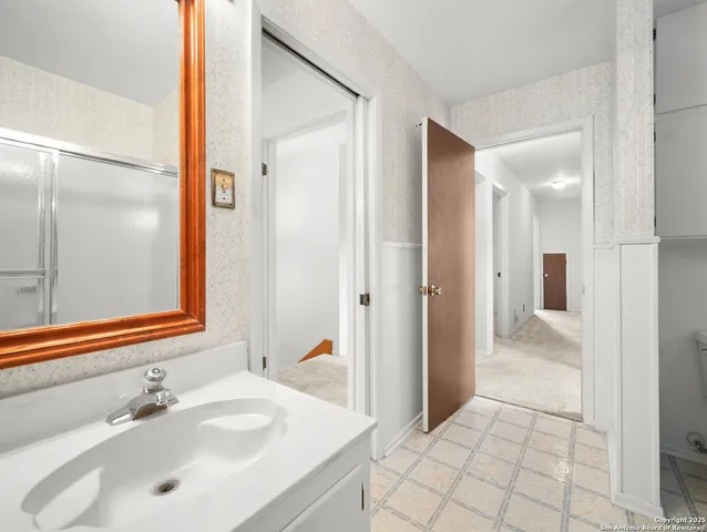 a bathroom with a sink and a mirror