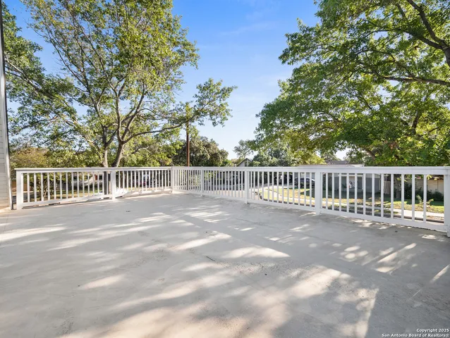 a view of a fence and trees