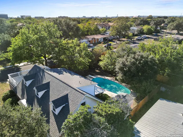 an aerial view of a house with a yard