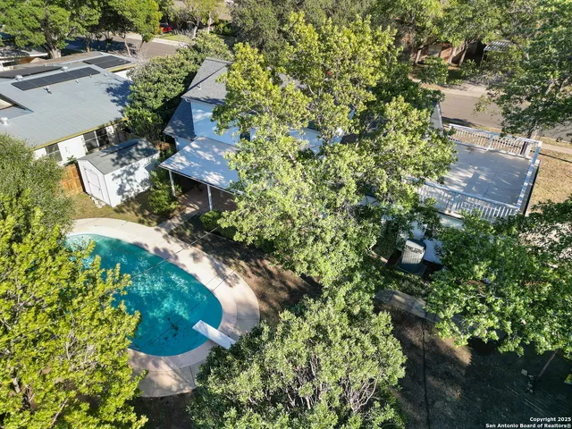 an aerial view of a house with a yard and outdoor seating