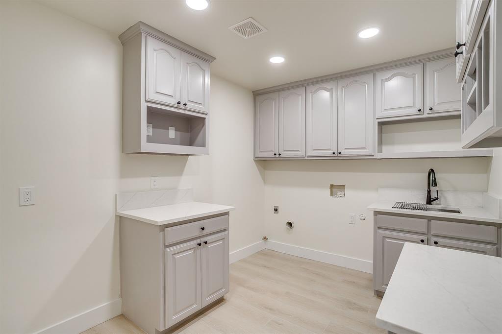 1432 Mount Gilead Road Keller, TX 76262 - Photo 16 of 40 a kitchen with white cabinets appliances and sink