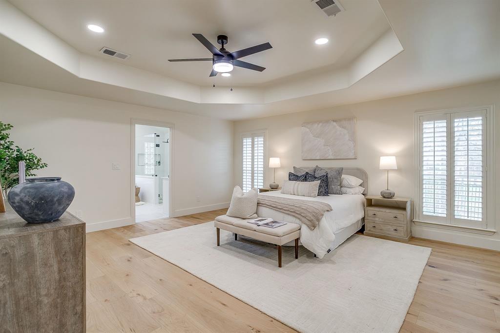1432 Mount Gilead Road Keller, TX 76262 - Photo 18 of 40 a spacious bedroom with a large bed and a chandelier