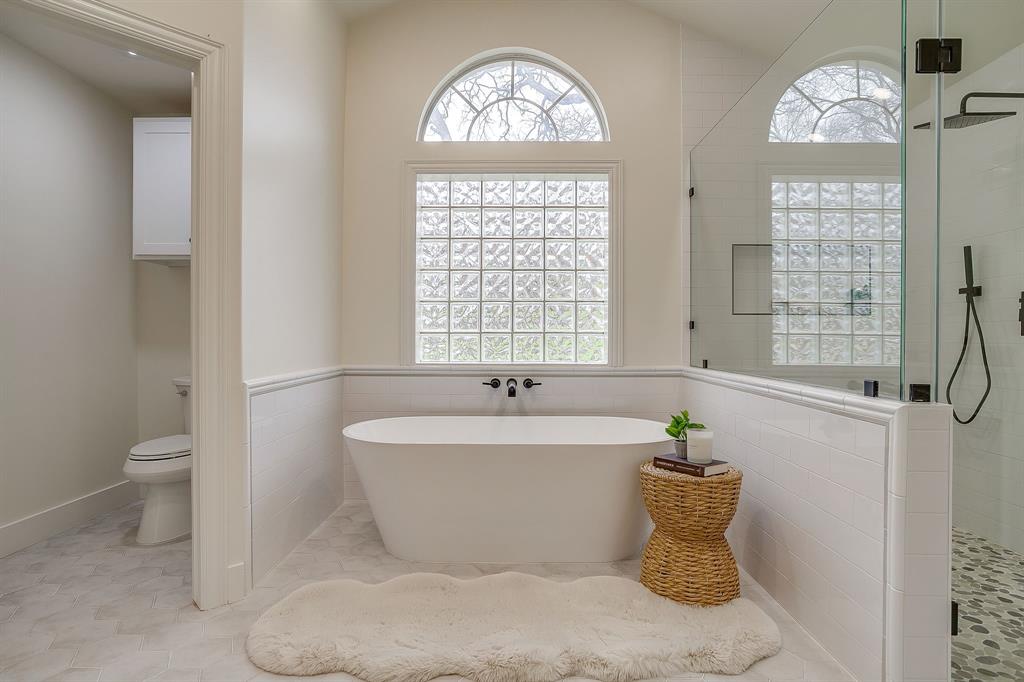 1432 Mount Gilead Road Keller, TX 76262 - Photo 19 of 40 a white bath tub sitting next to a white toilet