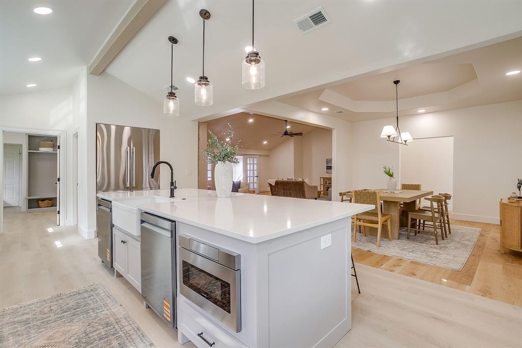 1432 Mount Gilead Road Keller, TX 76262 - Photo 9 of 40 a kitchen with a sink and a stove top oven with wooden floor