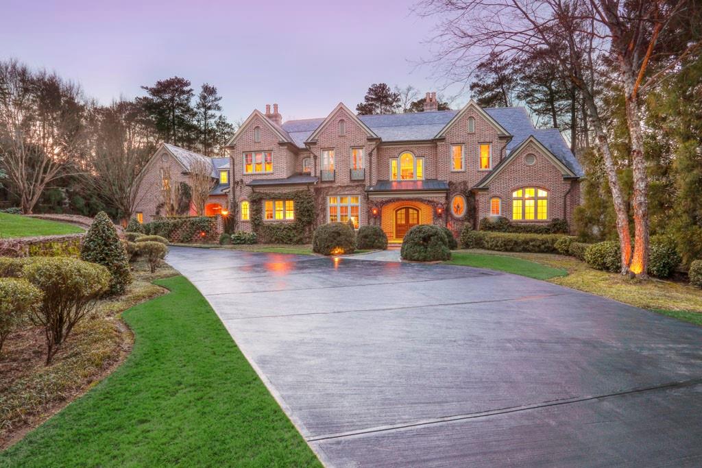 3610 Randall Mill Road Northwest Atlanta, GA 30327 - Photo 1 of 1 a front view of a house with a yard and large trees