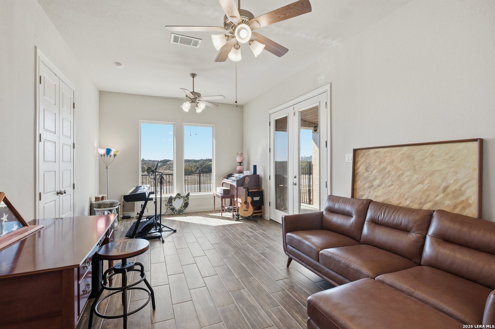 224 Mystic Shores Boulevard Spring Branch, TX 78070 - Photo 11 of 30 a living room with furniture a chandelier and a large window