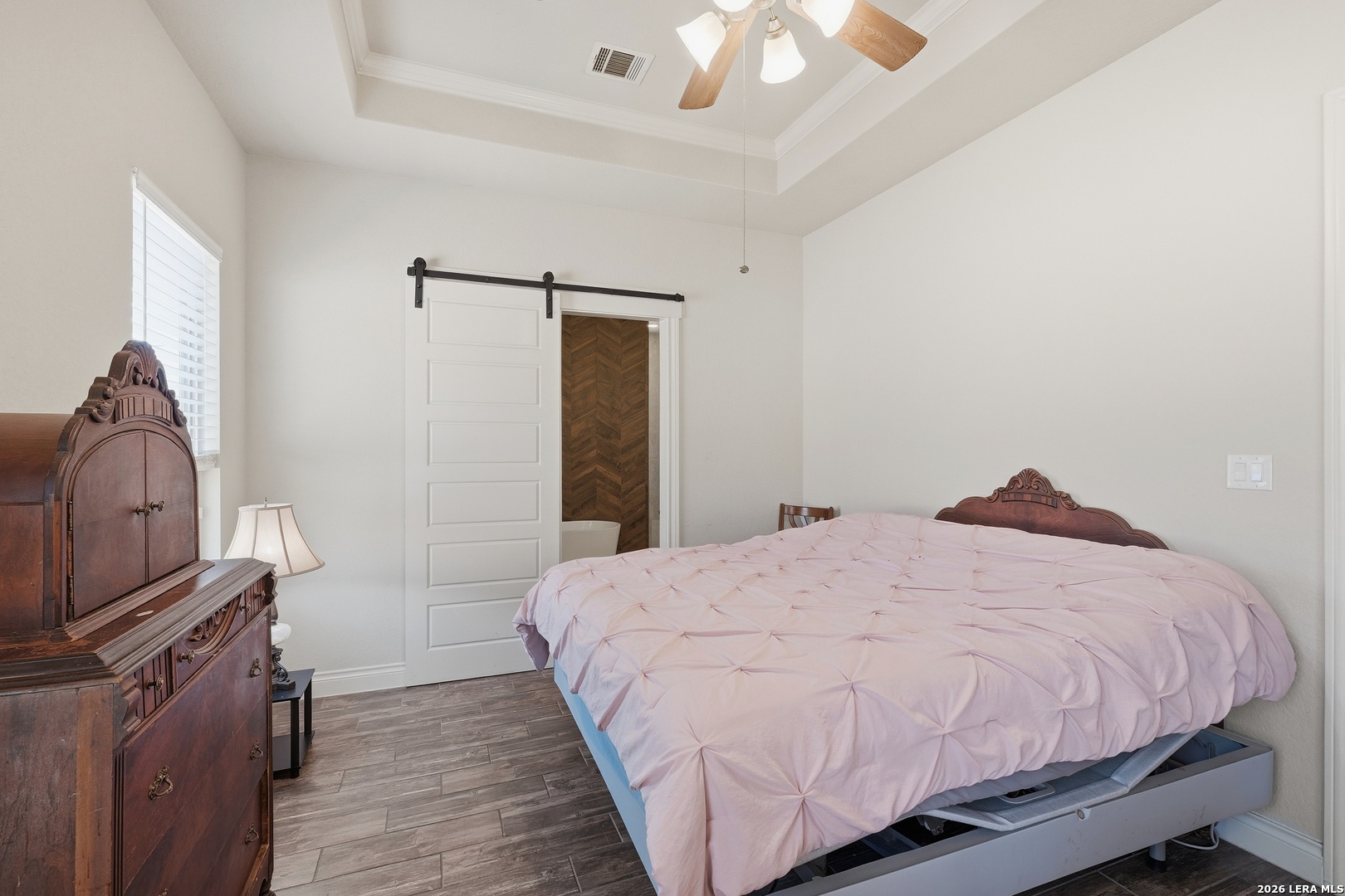 224 Mystic Shores Boulevard Spring Branch, TX 78070 - Photo 14 of 30 a bedroom with a bed dresser and a fireplace