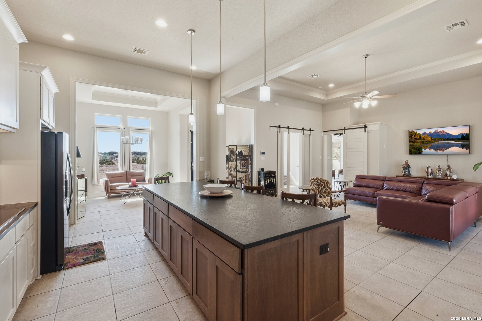 224 Mystic Shores Boulevard Spring Branch, TX 78070 - Photo 7 of 30 a kitchen with a stove a refrigerator a sink dishwasher with a dining table and chairs