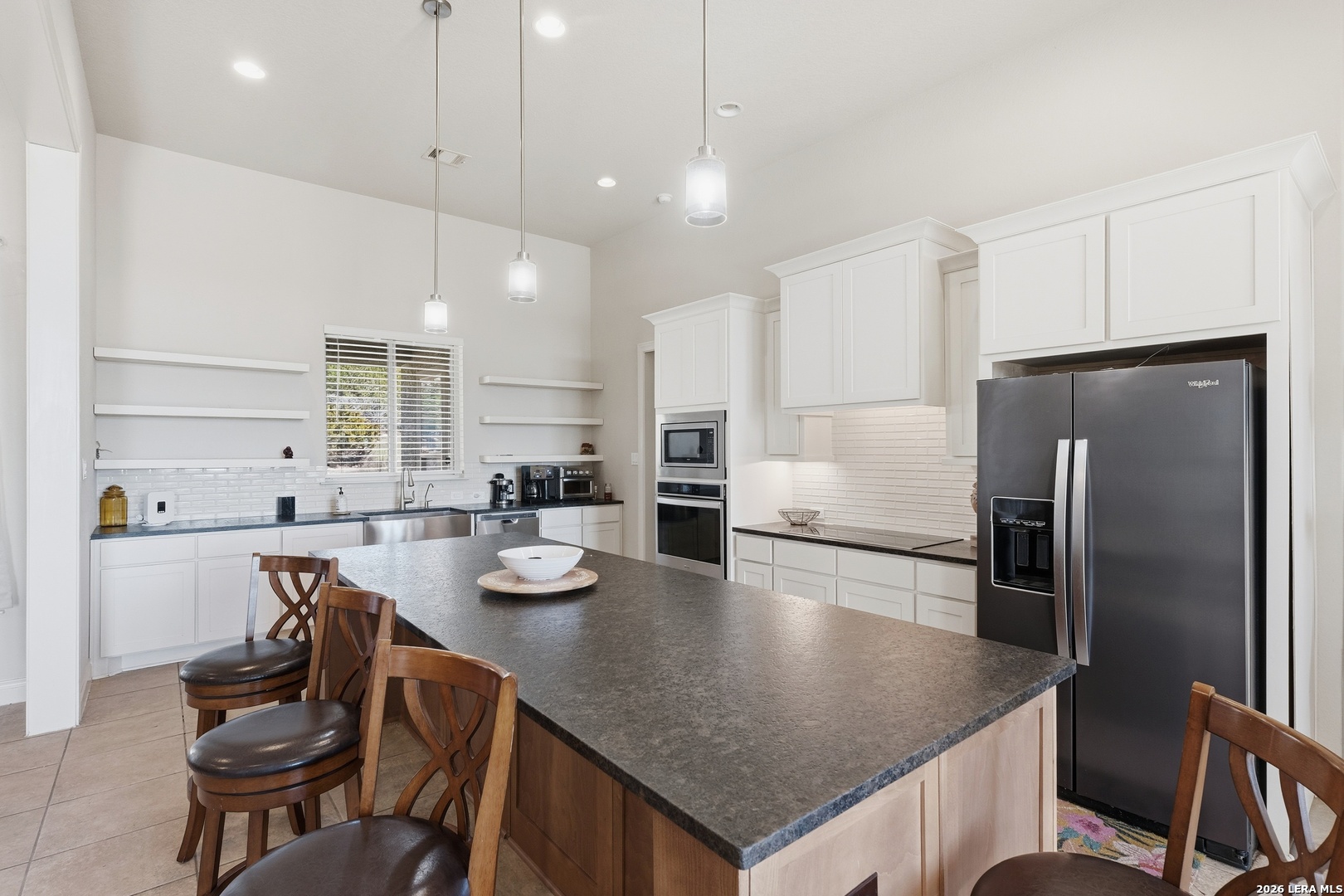 224 Mystic Shores Boulevard Spring Branch, TX 78070 - Photo 8 of 30 a kitchen with a refrigerator a stove a table and chairs