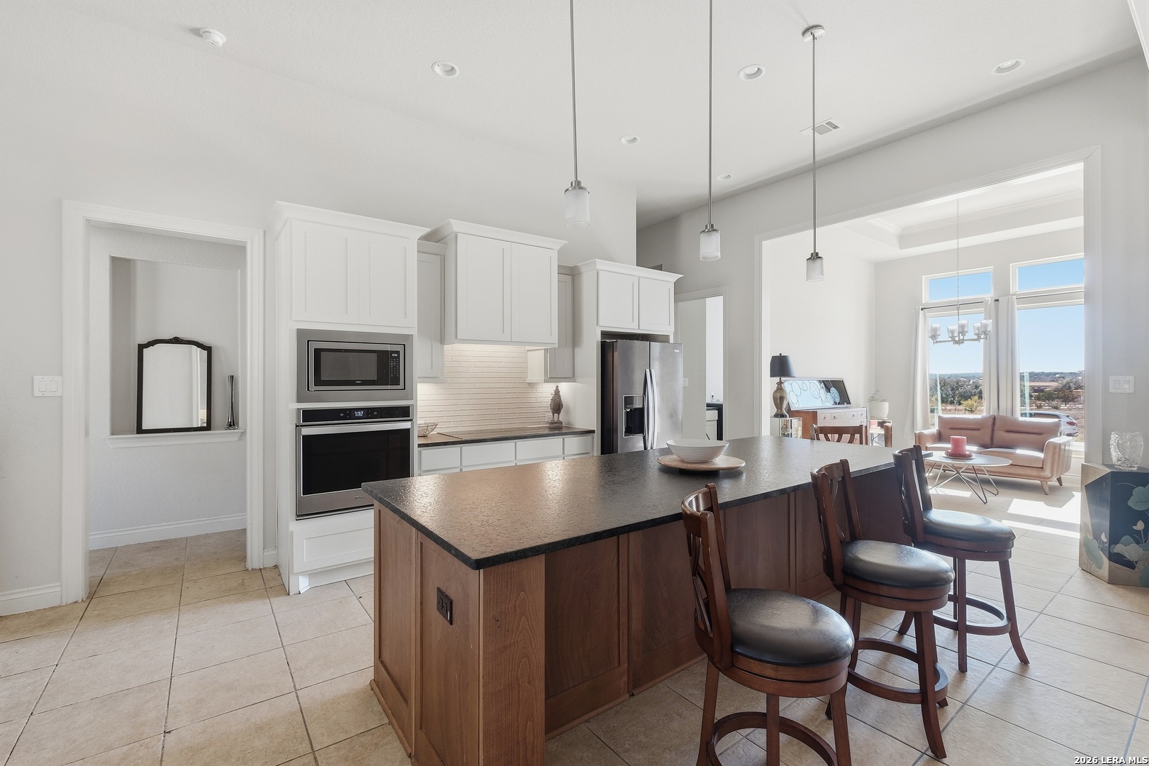 224 Mystic Shores Boulevard Spring Branch, TX 78070 - Photo 9 of 30 a kitchen with stainless steel appliances granite countertop a refrigerator a stove a sink a dining table and chairs