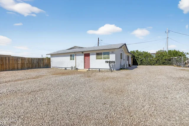 a view of a house with a backyard and a garage