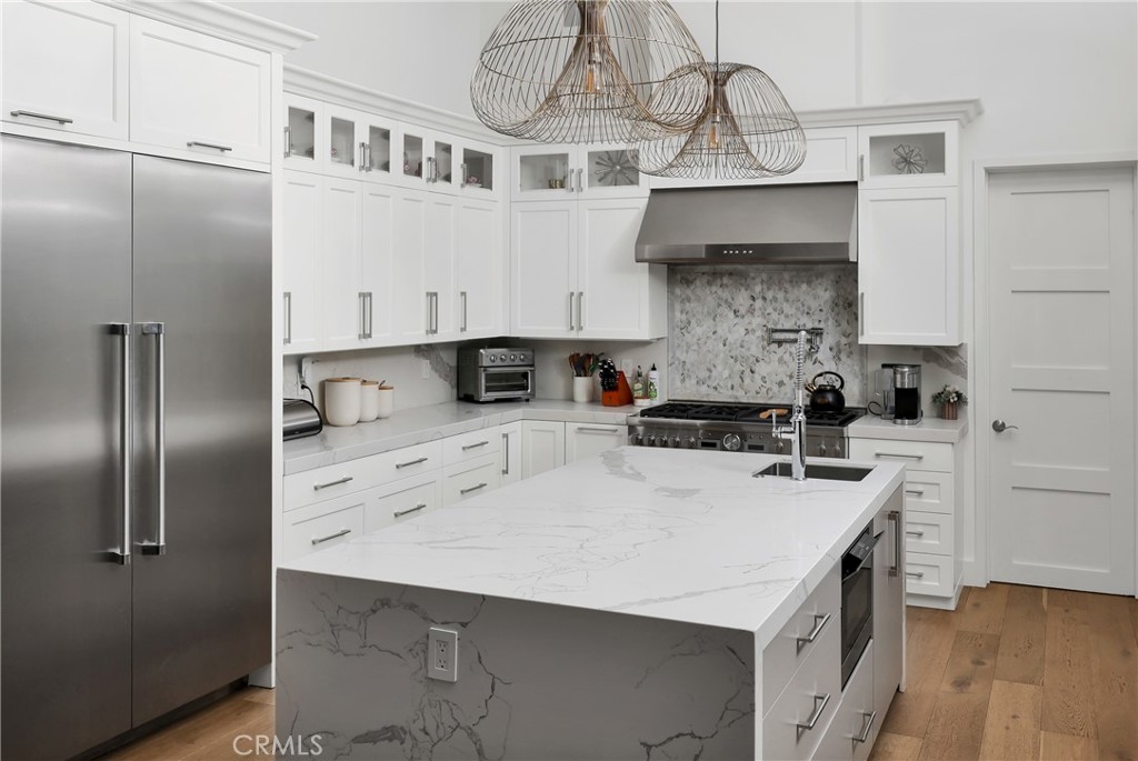 16582 Rio Vista Road San Diego, CA 92127 - Photo 12 of 49 a kitchen with stainless steel appliances a sink a stove and refrigerator