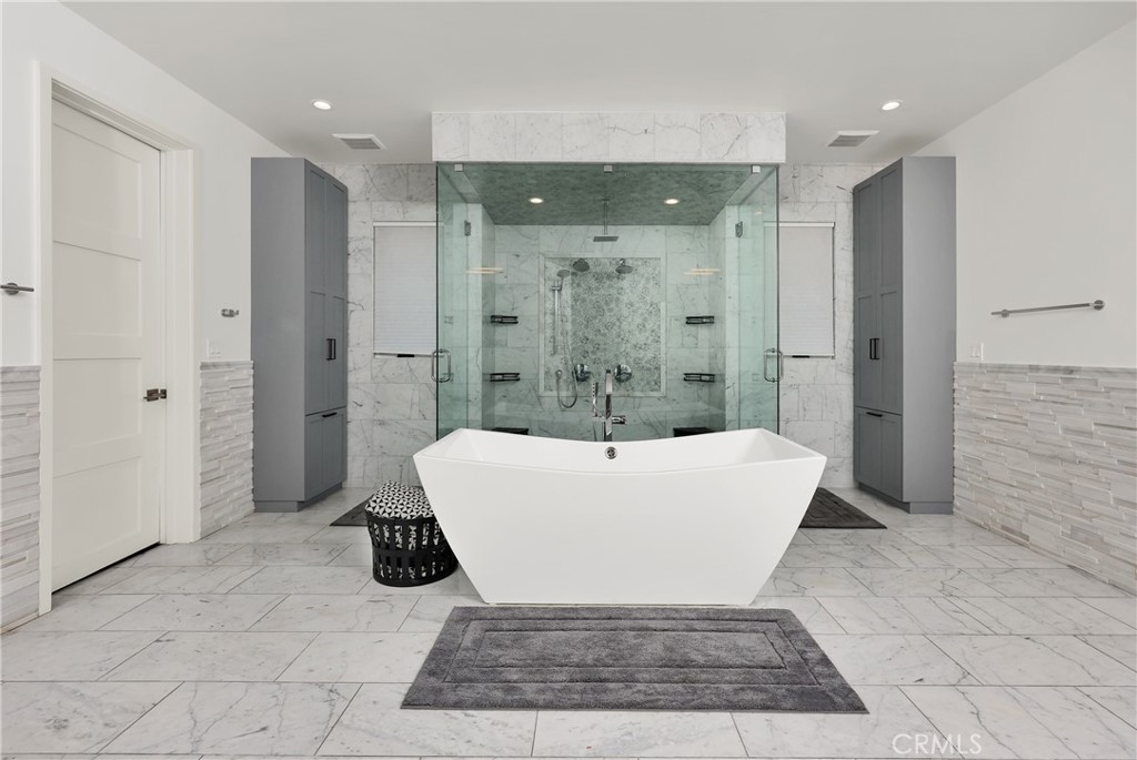 16582 Rio Vista Road San Diego, CA 92127 - Photo 19 of 49 a bathroom with a bathtub and shower