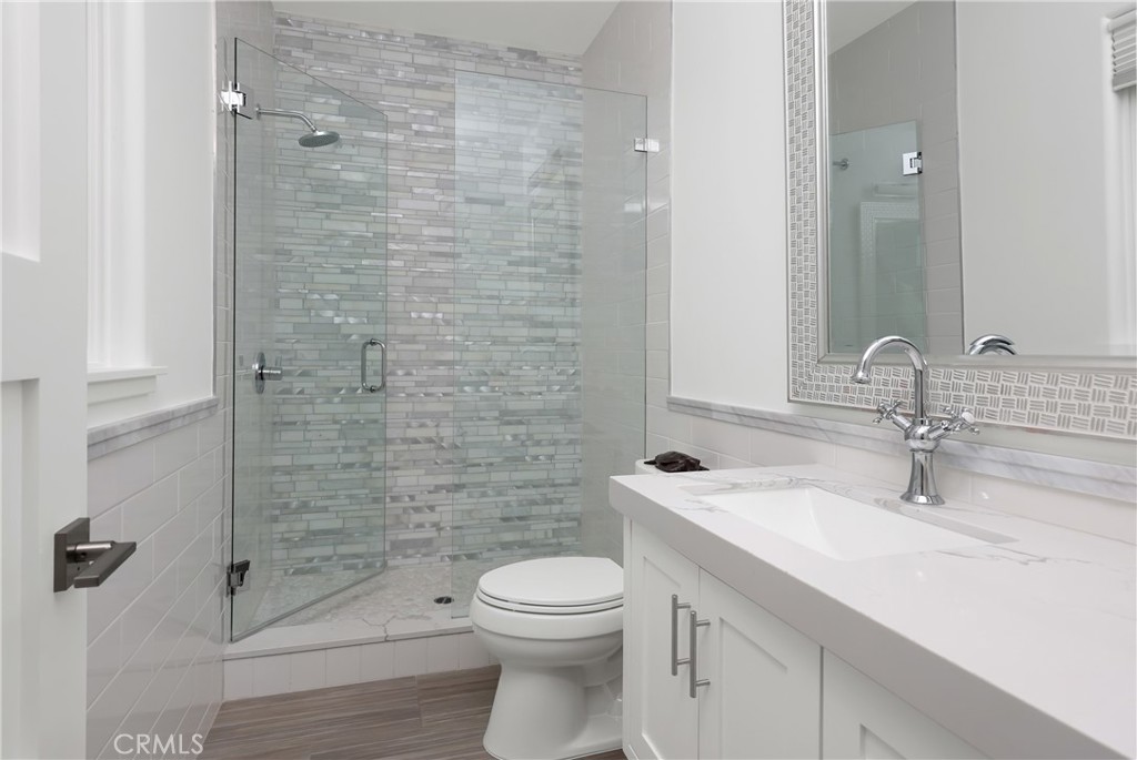 16582 Rio Vista Road San Diego, CA 92127 - Photo 29 of 49 a bathroom with a sink a toilet and shower