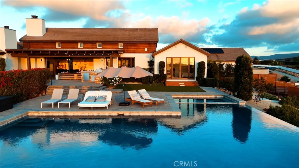 16582 Rio Vista Road San Diego, CA 92127 - Photo 3 of 49 a view of a house with swimming pool and sitting area