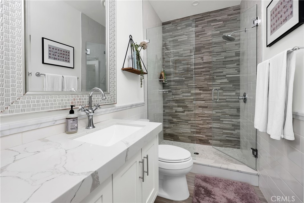 16582 Rio Vista Road San Diego, CA 92127 - Photo 31 of 49 a bathroom with a sink a toilet and shower