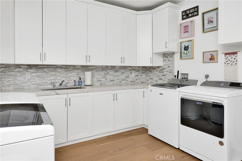 16582 Rio Vista Road San Diego, CA 92127 - Photo 32 of 49 a kitchen with granite countertop white cabinets and white appliances