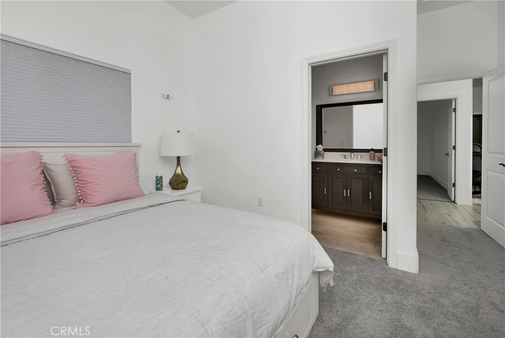 16582 Rio Vista Road San Diego, CA 92127 - Photo 44 of 49 a bedroom with a bed and black countertop