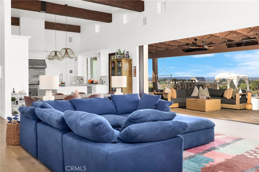 16582 Rio Vista Road San Diego, CA 92127 - Photo 9 of 49 a living room with furniture and a large mirror