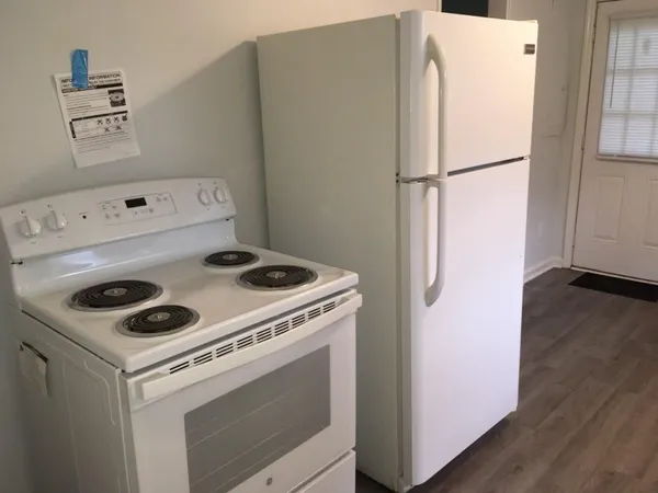 a white refrigerator freezer sitting inside of a kitchen