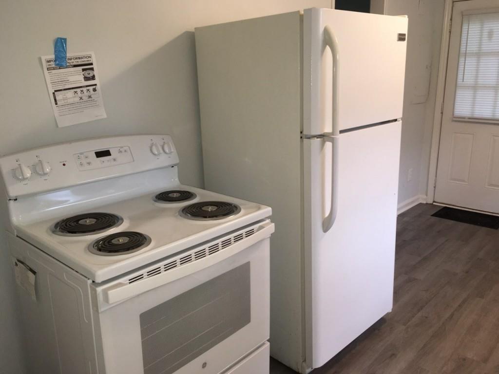 2335 Scotty Circle Decatur, GA 30032 - Photo 2 of 9 a white refrigerator freezer sitting inside of a kitchen