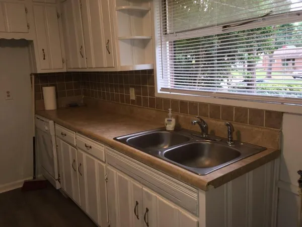 a kitchen with a sink and cabinets
