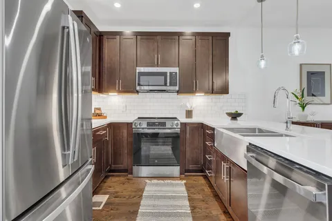 a kitchen with a sink stove and refrigerator