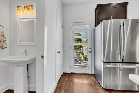 a view of kitchen with windows and refrigerator