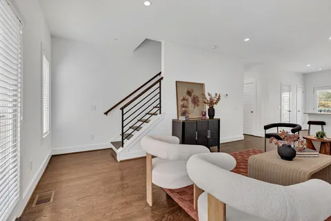 a view of living room with furniture and wooden floor