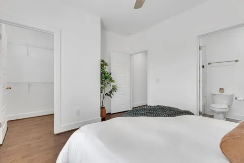 a bedroom with a bed and a potted plant