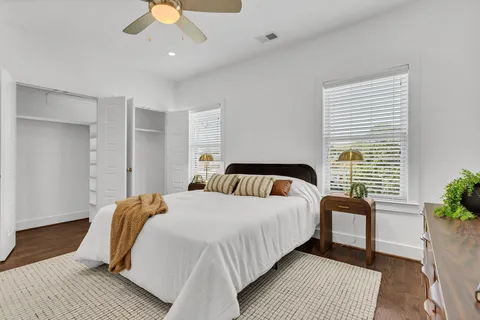 a bedroom with bed and a chandelier