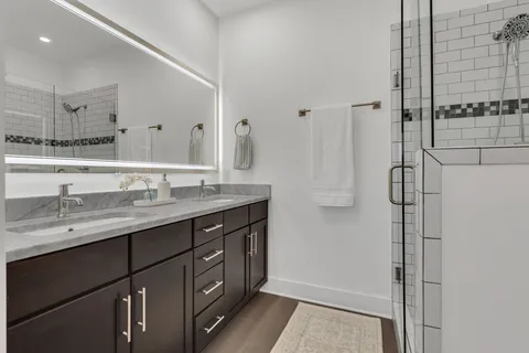 a bathroom with a double vanity sink and mirror