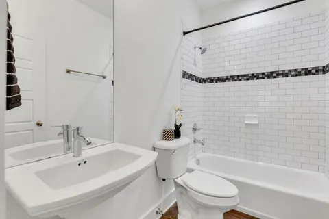 a bathroom with a sink toilet and shower