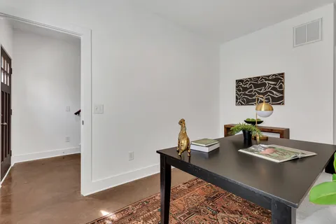 a view of a workspace with furniture