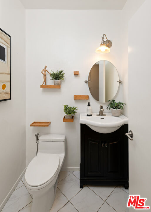 10627 Ashton Avenue, Unit 103 Los Angeles, CA 90024 - Photo 14 of 25 a bathroom with a sink and a mirror