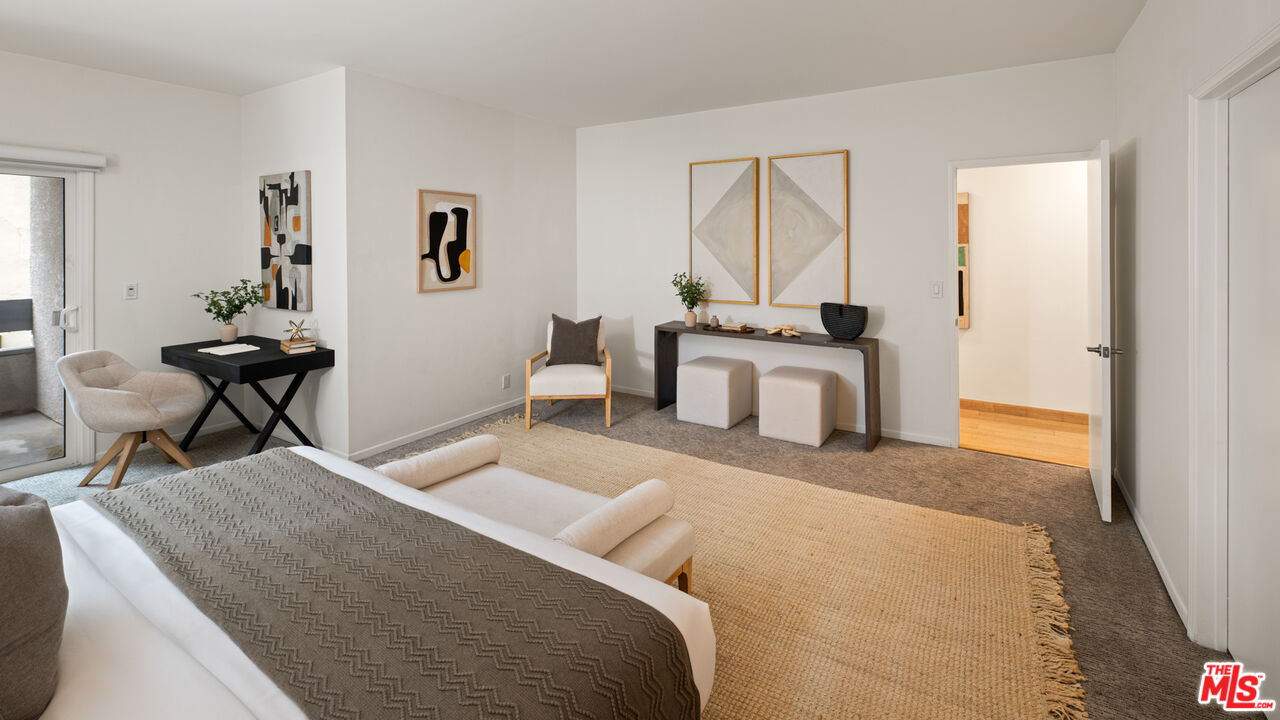 10627 Ashton Avenue, Unit 103 Los Angeles, CA 90024 - Photo 17 of 25 a bedroom with a bed and a table in it