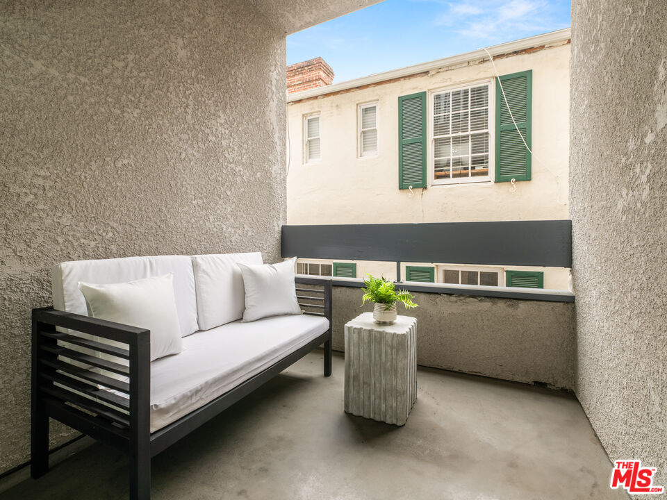 10627 Ashton Avenue, Unit 103 Los Angeles, CA 90024 - Photo 19 of 25 a living room with furniture and window