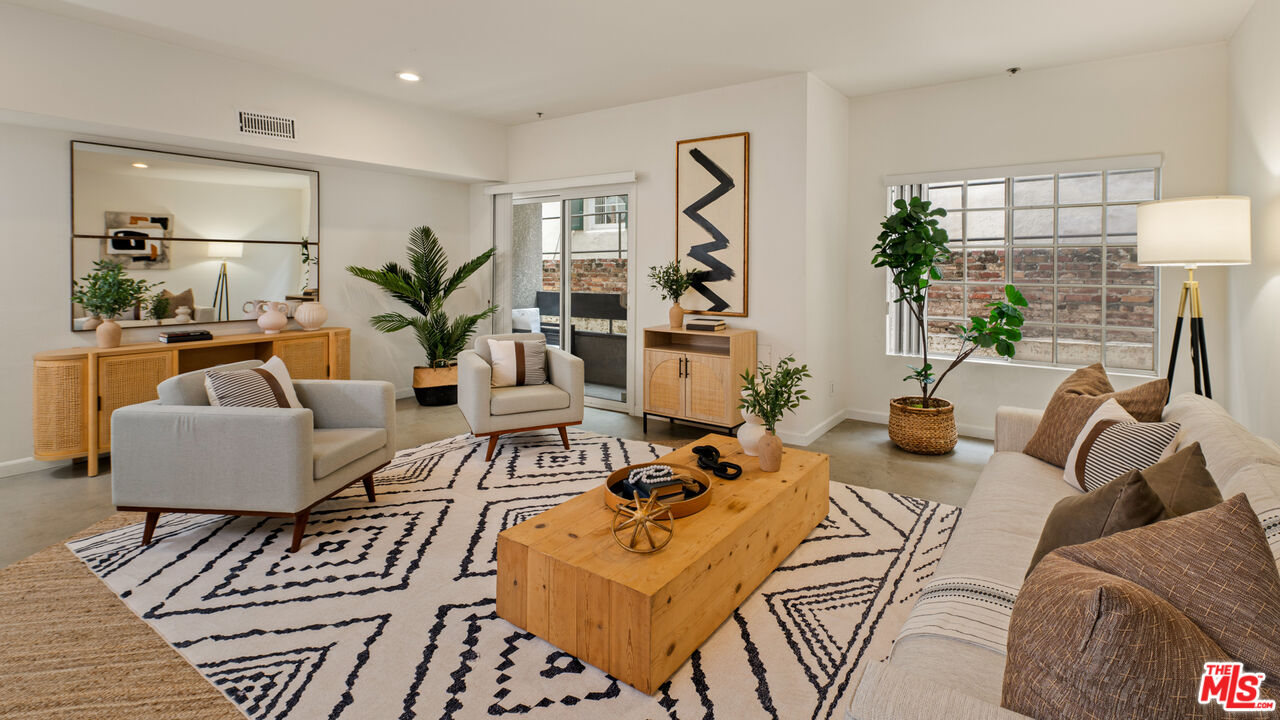 10627 Ashton Avenue, Unit 103 Los Angeles, CA 90024 - Photo 3 of 25 a living room with furniture or couch and a potted plant