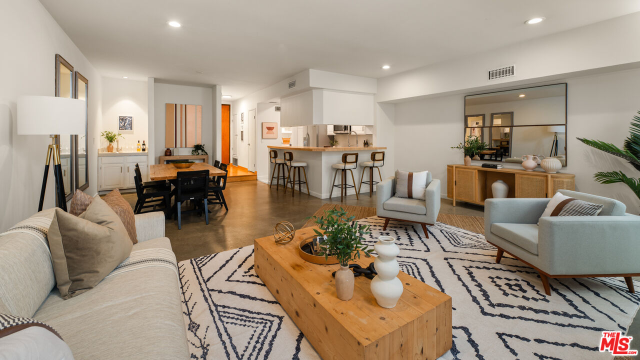 10627 Ashton Avenue, Unit 103 Los Angeles, CA 90024 - Photo 4 of 25 a living room with lots of furniture and kitchen view