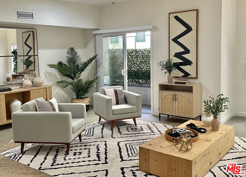 10627 Ashton Avenue, Unit 103 Los Angeles, CA 90024 - Photo 6 of 25 a living room with furniture a rug and a floor to ceiling window