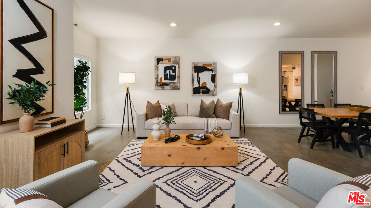 10627 Ashton Avenue, Unit 103 Los Angeles, CA 90024 - Photo 7 of 25 a living room with furniture a dining table and a potted plant