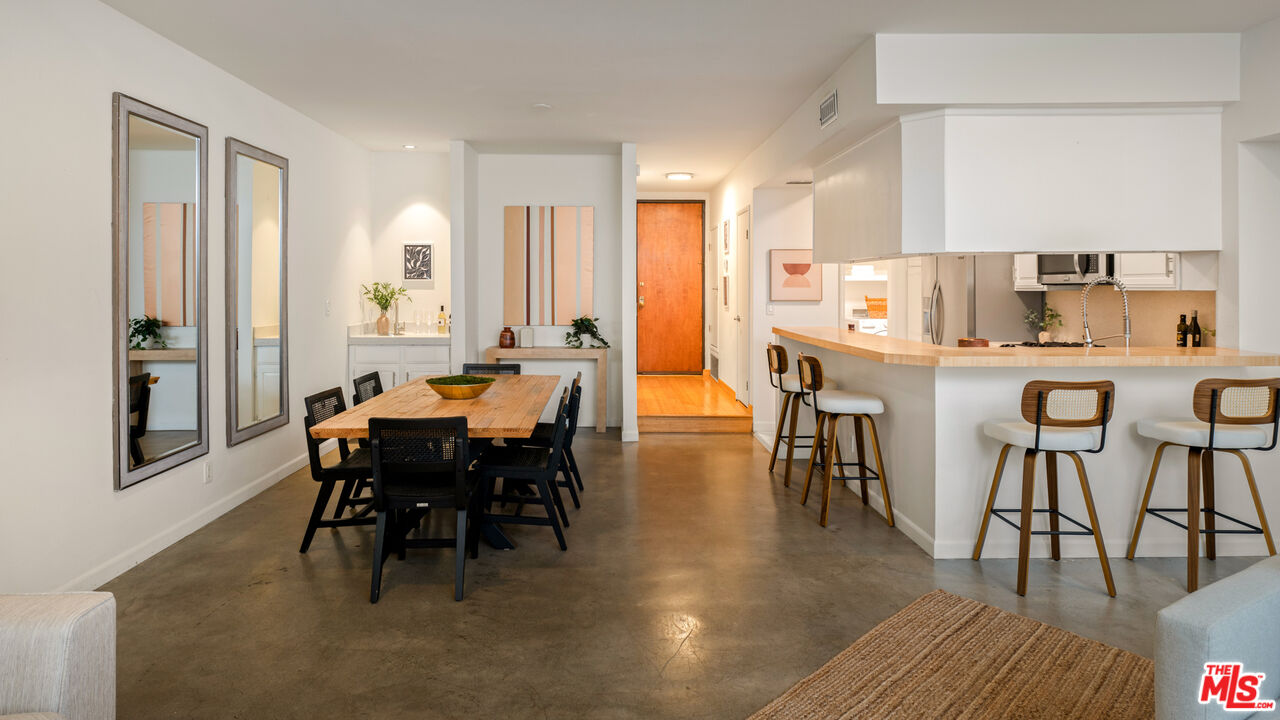 10627 Ashton Avenue, Unit 103 Los Angeles, CA 90024 - Photo 9 of 25 a view of a dining room with furniture and wooden floor