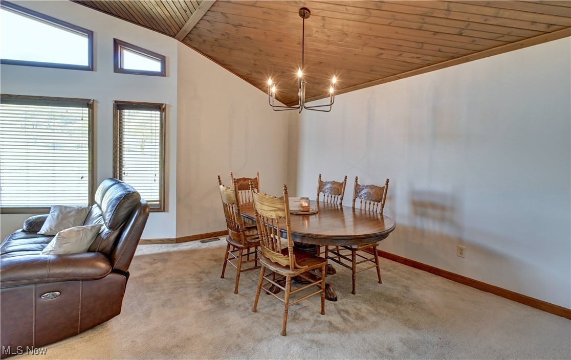 5747 Middle Run Road Dover, OH 44622 - Photo 12 of 30 Carpeted dining area with wood ceiling, a chandelier, and high vaulted ceiling