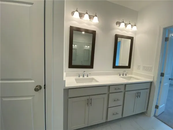 a bathroom with a double vanity sink and mirror