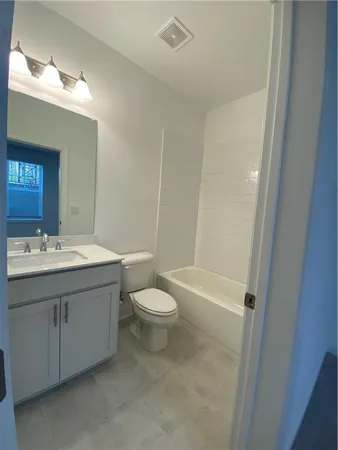 a bathroom with a double vanity sink toilet and shower