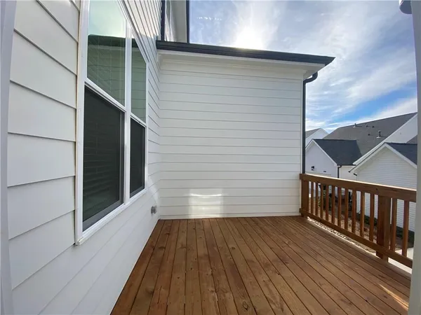a view of a balcony with wooden floor and stairs