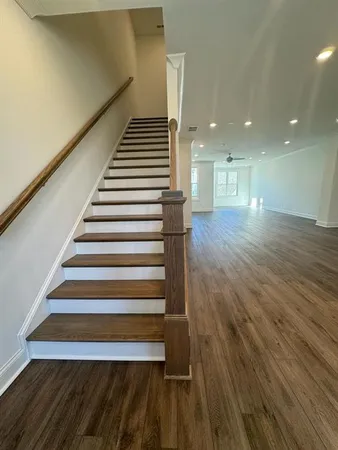 a view of entryway and hall with wooden floor