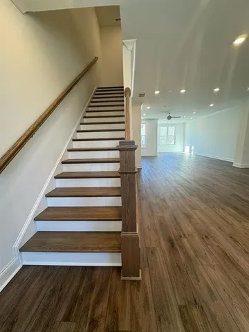 a view of entryway and hall with wooden floor