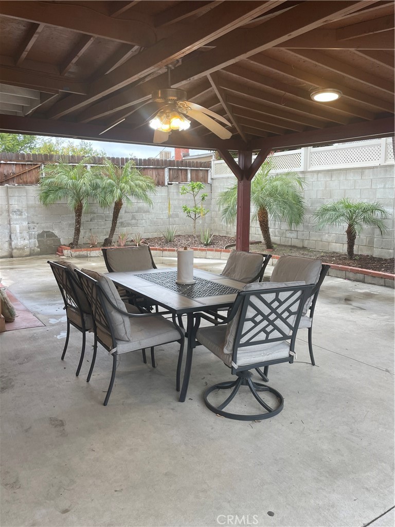 9362 Gullo Avenue Arleta, CA 91331 - Photo 25 of 29 a view of a patio with table and chairs under an umbrella with a roof