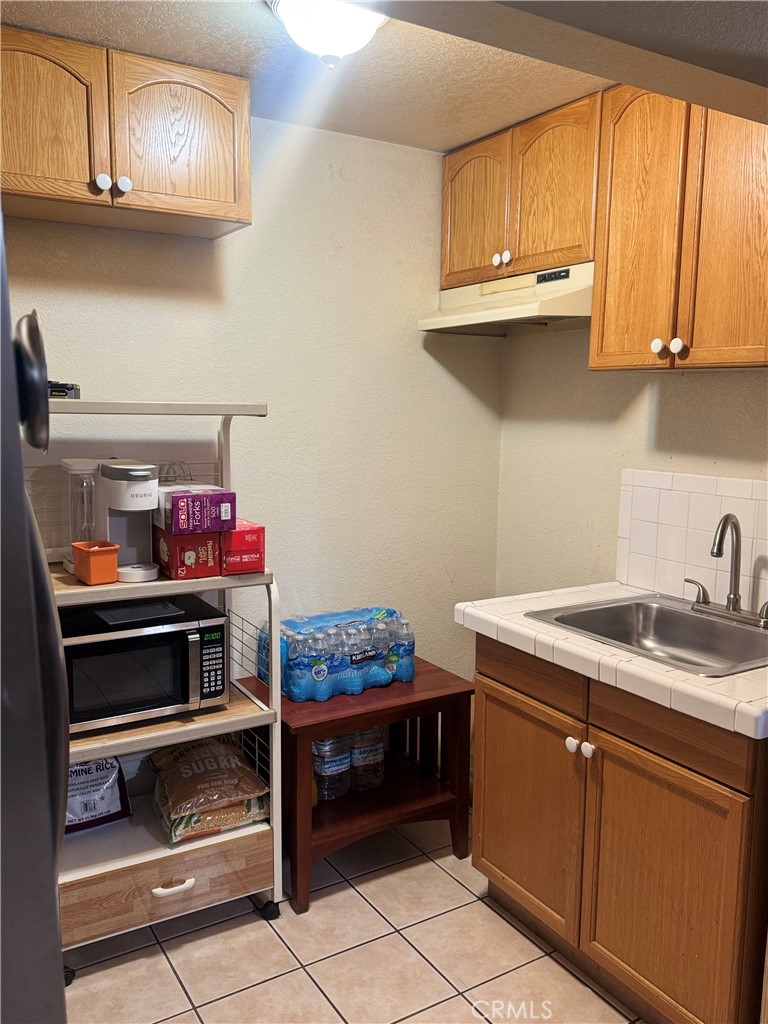 9362 Gullo Avenue Arleta, CA 91331 - Photo 27 of 29 a kitchen with stainless steel appliances granite countertop a sink dishwasher stove and cabinets